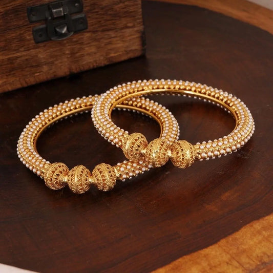 Antique gold pearl bangles with intricate textured bead design for South Indian weddings, Onam celebrations, and traditional festive wear.